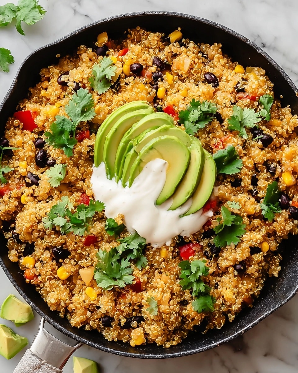 A black skillet filled with a colorful quinoa dish containing visible layers of golden quinoa, black beans, yellow corn, and red bell pepper pieces mixed evenly throughout. On top, there is a smooth white cream or sour cream layer placed next to three thin slices of green avocado, arranged in a slight curve. Small green cilantro leaves are scattered on the cream and around the dish. The skillet is resting on a white marbled textured surface with some avocado chunks and cilantro sprigs placed nearby. Photo taken with an iphone --ar 4:5 --v 7