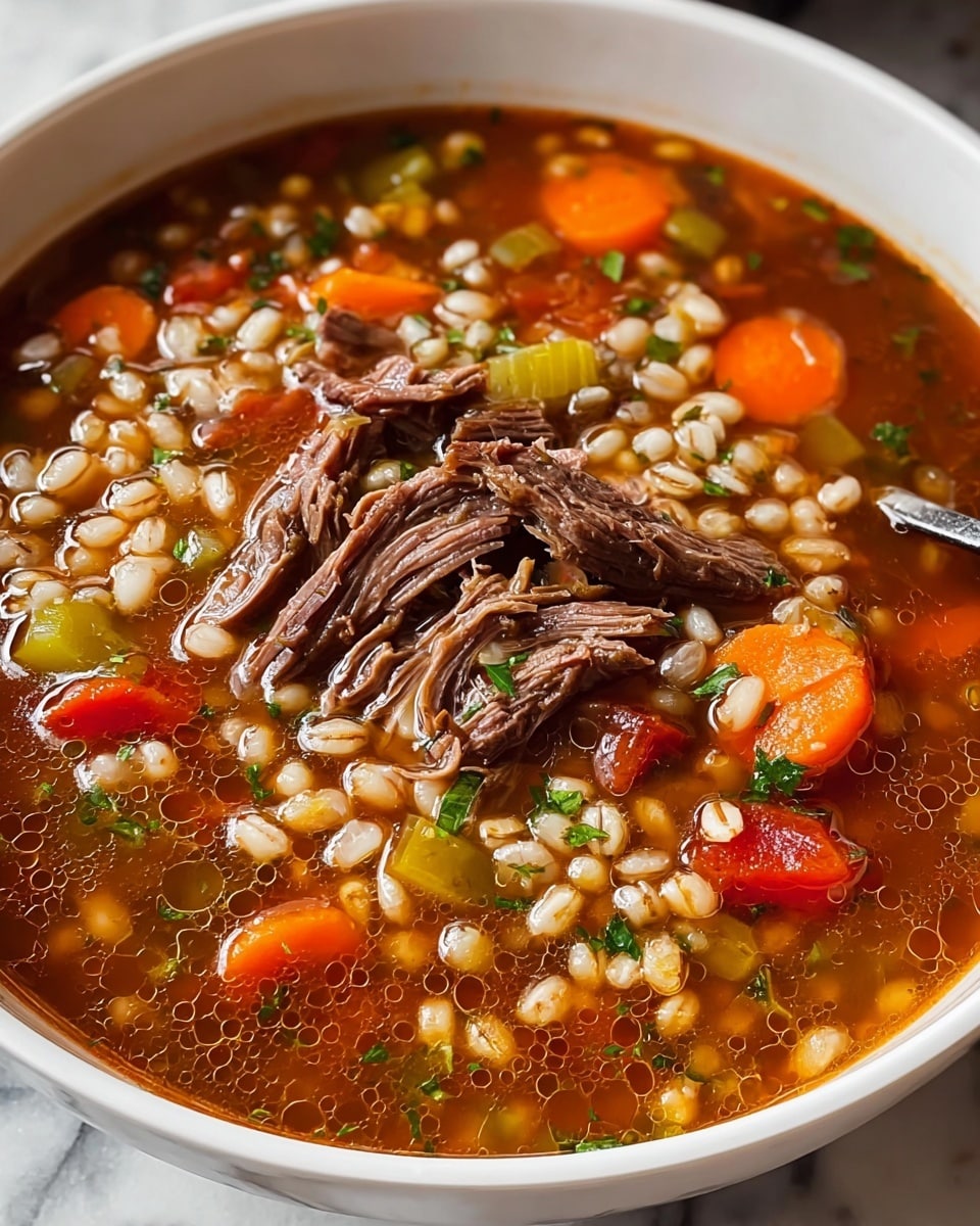 A white bowl filled with a thick soup, this soup has a brownish-red broth base with small oil droplets on the surface. Inside, there are visible chunks of shredded brown meat, bright orange carrot slices, small pieces of light green celery, and small white grains that look like barley. There are also some small bits of red bell pepper and green herbs sprinkled on top. The soup's texture looks hearty and chunky, with the pieces floating evenly throughout the broth. The bowl is set on a surface with a white marbled texture. photo taken with an iphone --ar 4:5 --v 7