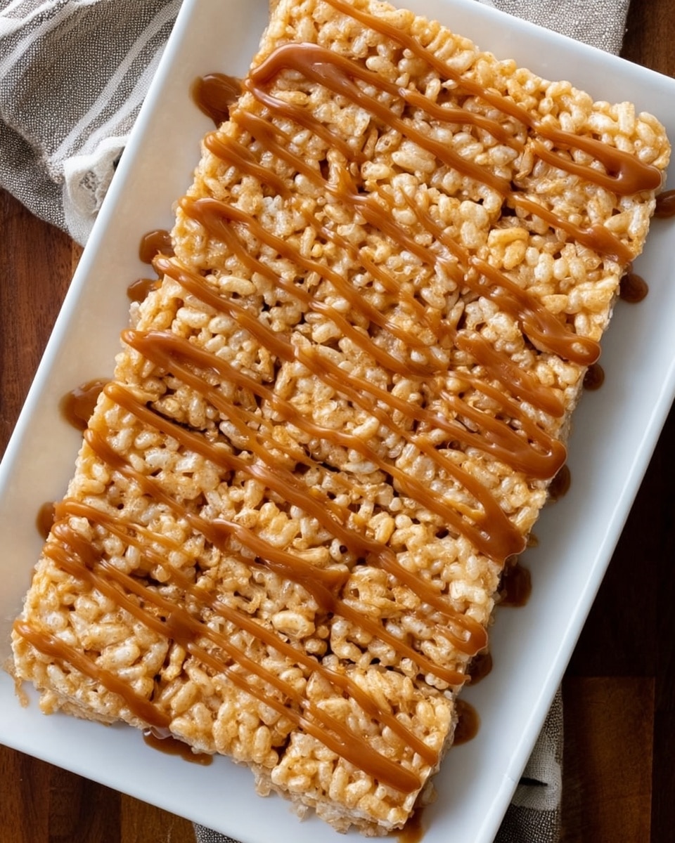 A close-up top view of a rectangular white dish filled with a single thick layer of golden rice crispy treats, showing a light, crunchy texture. The surface is drizzled with uneven streaks of glossy, rich caramel sauce that adds a shiny brown layer on top. The dish is set on a wooden surface, but the background should be changed to a white marbled texture. Photo taken with an iphone --ar 4:5 --v 7