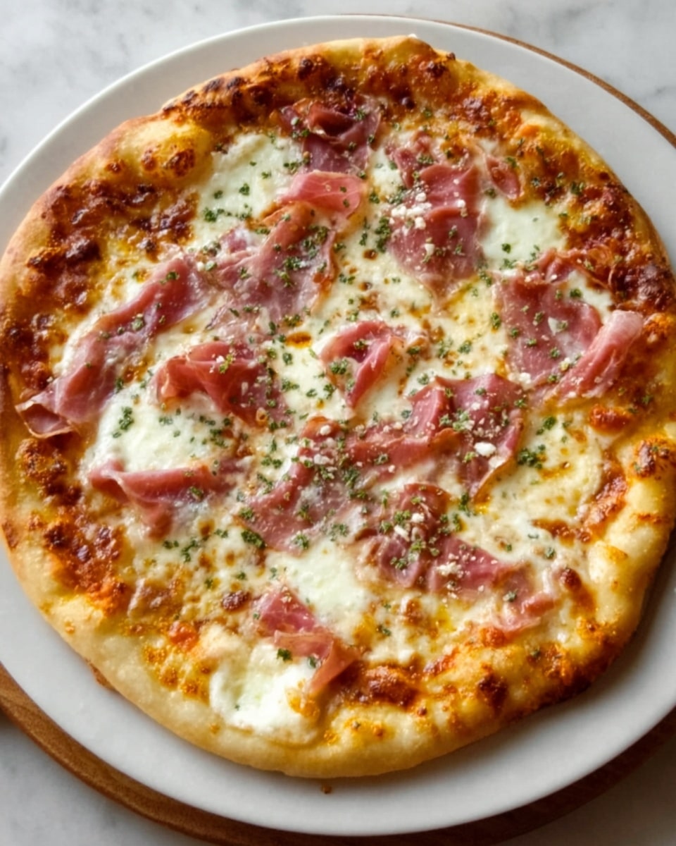 A round pizza with a golden-brown crust, topped with a layer of melted white cheese, scattered pieces of thin pink ham, and small green herb sprinkles. The cheese looks creamy and bubbly, covering most of the surface except the edges of the crust. The pizza is placed on a simple white plate, which sits on a white marbled texture background. The lighting shows a warm and fresh look. photo taken with an iphone --ar 4:5 --v 7