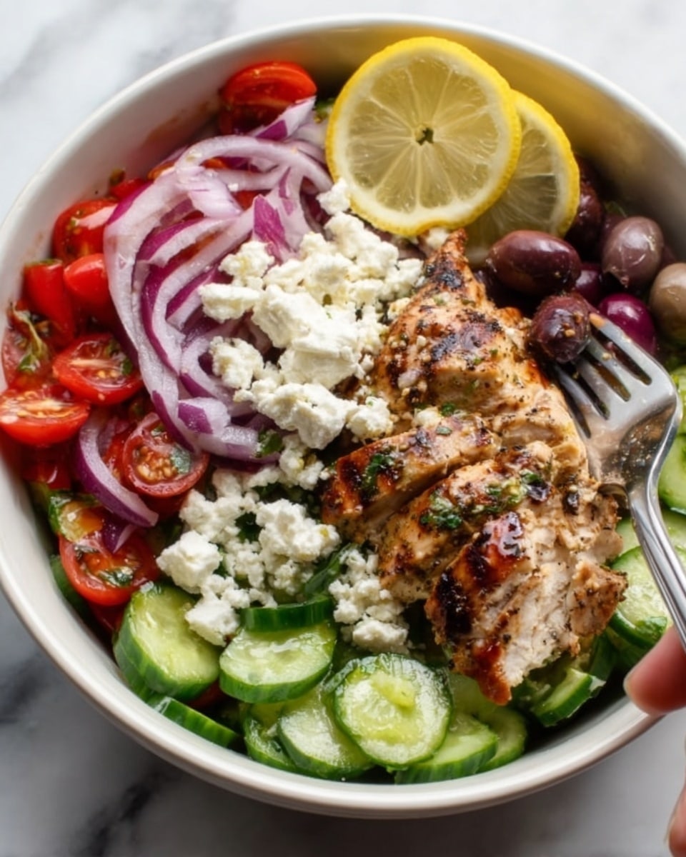 A white bowl filled with a colorful salad with seven distinct layers: the bottom layer is dark green cucumbers sliced thick, above that are halved bright red cherry tomatoes, then crumbled white feta cheese scattered generously, followed by thin purple onion rings on one side, next to sliced olives in dark purple and black, topped with a large piece of grilled chicken breast with golden brown grill marks and a slightly shiny texture, and finished with two lemon wedges placed on the edge. The bowl sits on a white marbled surface, and a woman's hand is visible holding a fork ready to eat, photo taken with an iphone --ar 4:5 --v 7