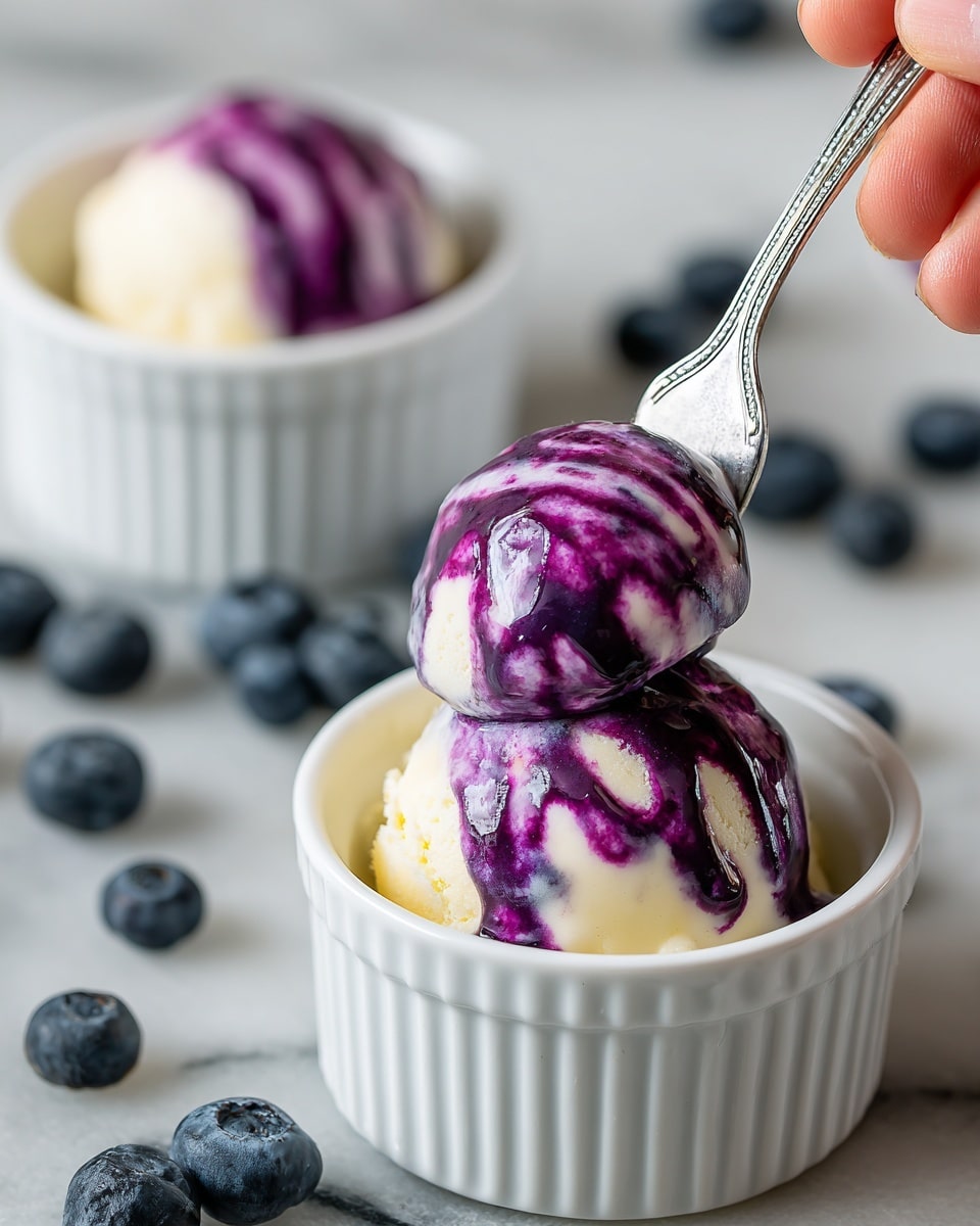 Two scoops of ice cream are served in a white ramekin placed on a white marbled surface. The bottom scoop is creamy white with smooth texture, topped by a smaller scoop that also has creamy white color but is streaked with bright purple swirls. A blueberry sits atop the back ramekin scoop, while fresh blueberries are scattered around. A silver fork held by a woman's hand lifts the purple-streaked scoop from the front ramekin. Photo taken with an iphone --ar 4:5 --v 7